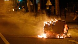 A trash can burns in the street during clashes in Villeneuve-la-Garenne, in the northern suburbs of Paris, in the early hours on Tuesday after clashes between police and protesters.