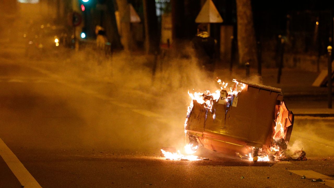 A trash can burns in the street during clashes in Villeneuve-la-Garenne, in the northern suburbs of Paris, early on April 21.