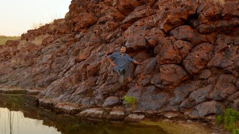 Roger Fu stands on a rocky outcrop of the Honeyeater Basalt in Western Australia's Pilbara Craton. These are exposed ancient lava rocks that were part of Earth's active crust that was moving 3.2 billion years ago.