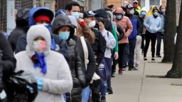 Hundreds impacted by the COVID-19 virus outbreak wait in line for boxes of food at a Salvation Army center in Chelsea, Mass., Wednesday, April 22, 2020. (AP Photo/Charles Krupa)