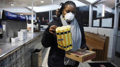 Andrea Wyatt of Inglewood, Calif., collects her snacks March 19 at a drive-in in Paramount, Calif.