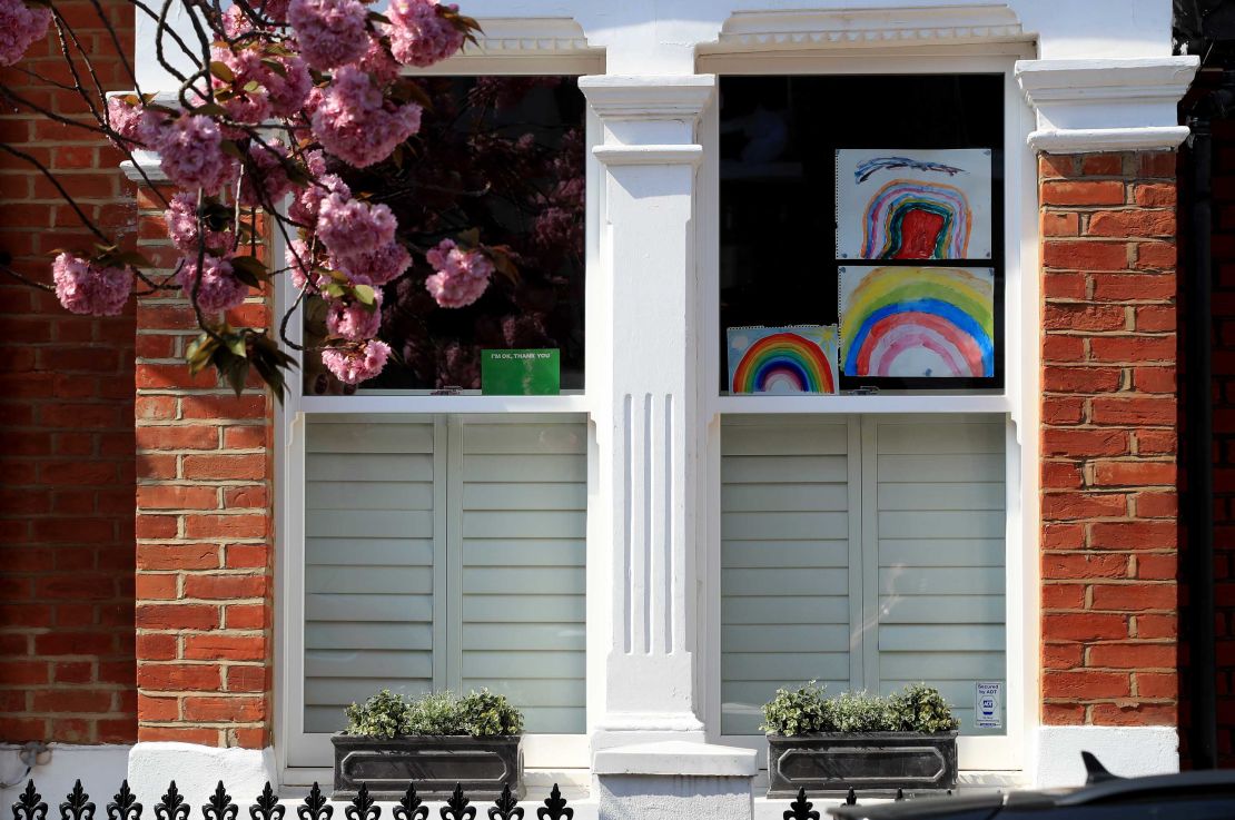 Homemade drawings of a rainbow are pictured in a window on April 9 in London, England.