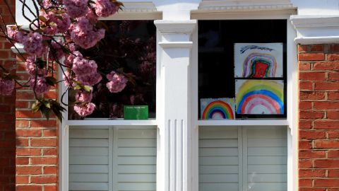 Homemade drawings of a rainbow are pictured in a window on April 9 in London, England.