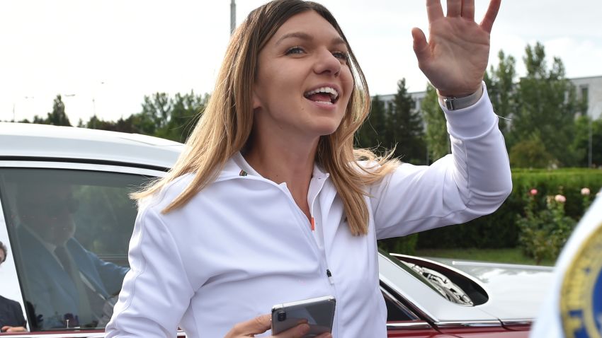 2019 Wimbledon Women's singles champion, Romania's tennis player Simona Halep (C), waves to fans outside Henry Coanda International Airport in Bucharest on July 15, 2019. (Photo by Daniel MIHAILESCU / AFP)        (Photo credit should read DANIEL MIHAILESCU/AFP via Getty Images)