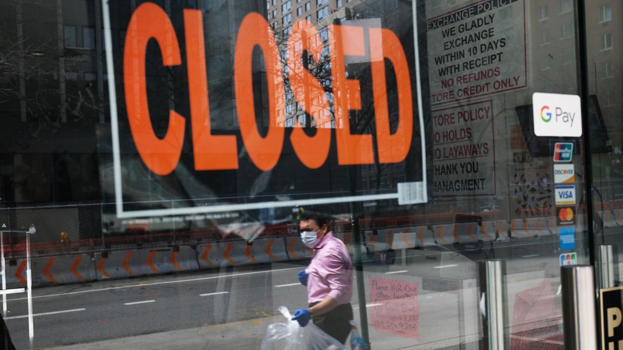 NEW YORK CITY - APRIL 17: A closed sign is displayed in the window of a business in a nearly deserted lower Manhattan on April 17, 2020 in New York City, United States. New York City has been the hardest hit city in America from COVIT-19, with overwhelmed hospitals and a struggling economy.