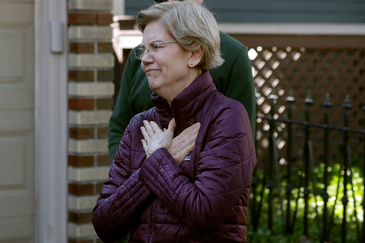 Warren acknowledges supporters as she arrives to speak to the media outside her home in Cambridge, Massachusetts, in March 2020. She had just dropped out of the presidential race.