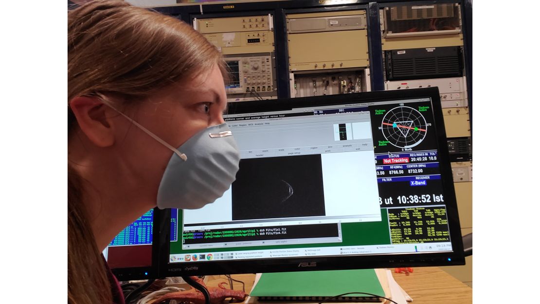 Anne Virkki, the head of planetary radar at the Arecibo Observatory, wears her face mask with a range-Doppler radar image of asteroid 1998 OR2.