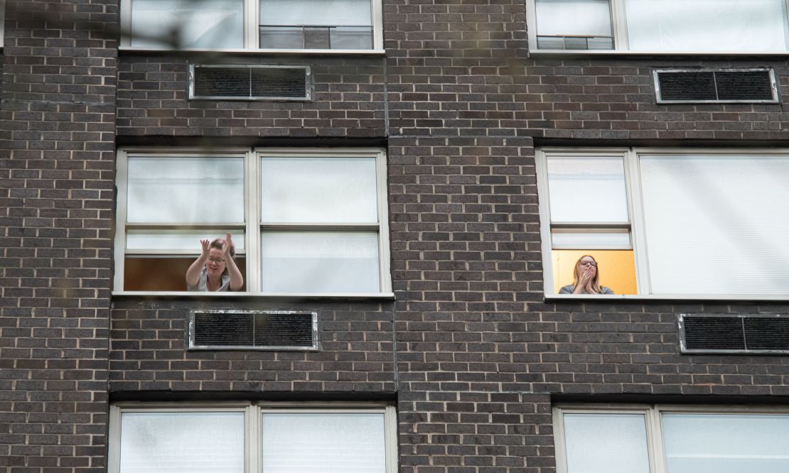 People applaud from their windows to show gratitude to medical staff and essential workers on the frontlines of the coronavirus pandemic on April 3, 2020 in New York City.