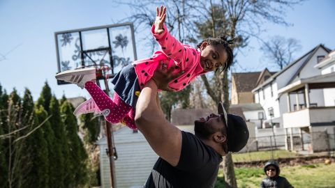 Mo Major exercises in the backyard with his children Marley, 4, and Max, 5, on March 26, 2020, in Mount Vernon, New York. Mo was laid off as a chef consultant and his wife furloughed as a preschool teacher as schools closed due to the coronavirus pandemic.