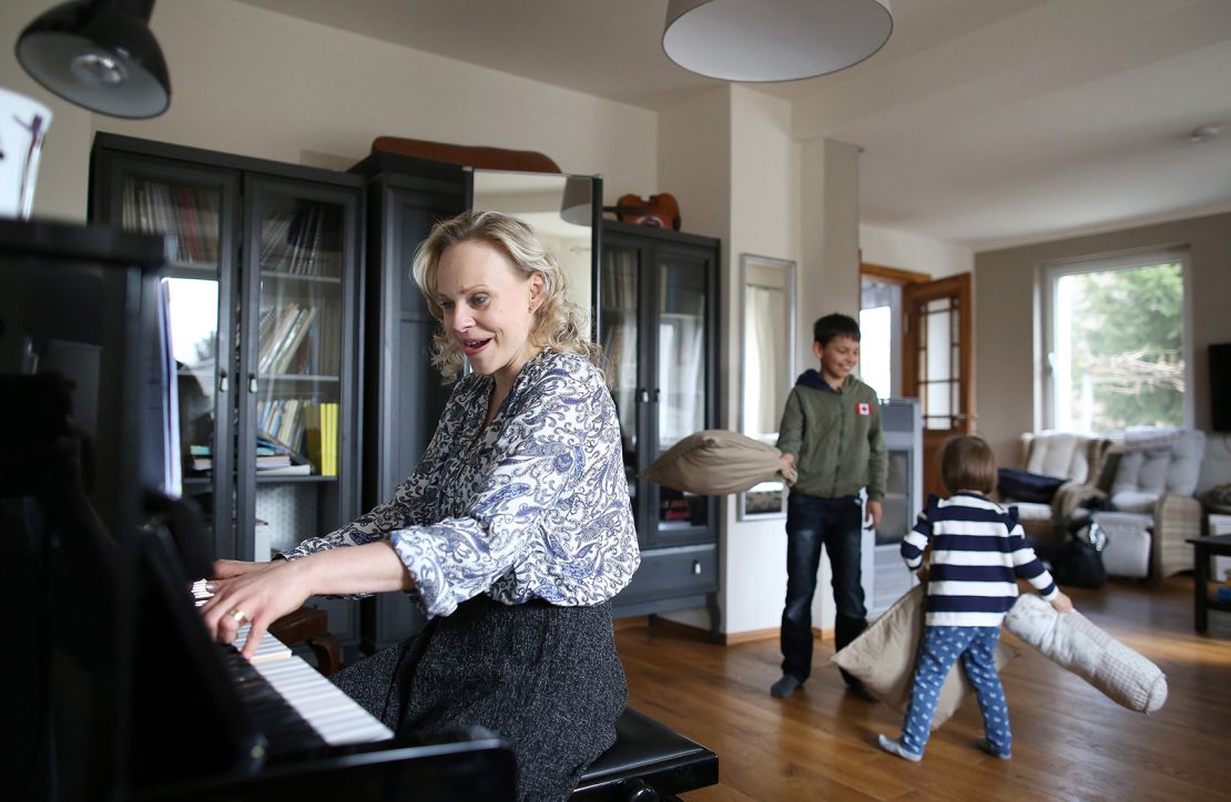 Lilli Wuenscher, a sopranist and member of the ensemble of Leipzig's opera house, sings as her 10-year-old son Joshua and 3-year-old daughter Josephine have a pillow fight at their home, where the family stays confined due to the pandemic on April 3, 2020, on the outskirts of Leipzig, eastern Germany.