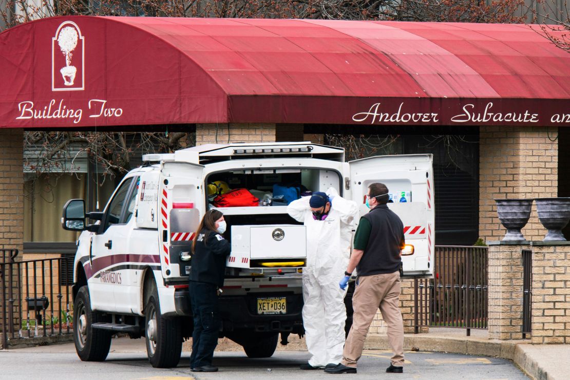 Medical workers put on masks and personal protective equipment while preparing to transport a body at Andover Subacute and Rehabilitation Center on April 16, 2020 in Andover, New Jersey. (Eduardo Munoz Alvarez/Getty Images)