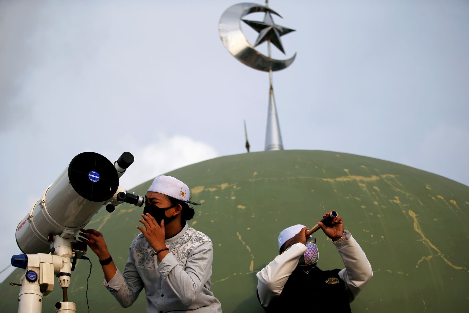 People view the moon from the roof of the Al Musariin Mosque in Jakarta, Indonesia. They were waiting to mark the official first night of Ramadan.