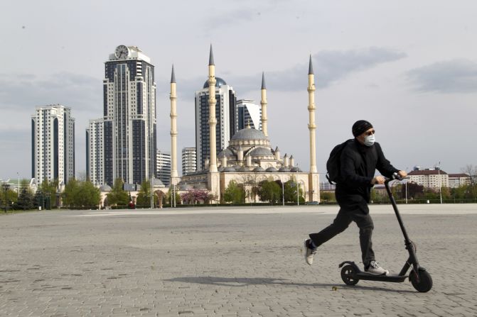 A man rides a scooter in front of a closed mosque in Grozny, Russia, on April 23.