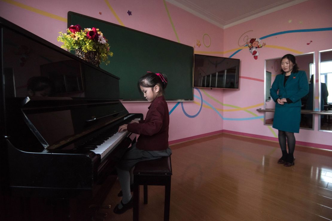 A girl plays the piano at a school for orphans on the outskirts of Pyongyang.