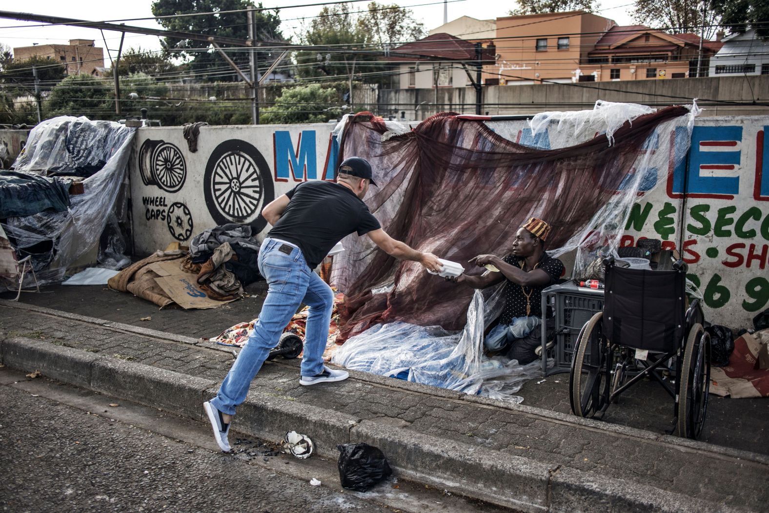 A man donates food to another in Johannesburg on April 23. "Zakat," or almsgiving, is one of the five pillars of Islam.