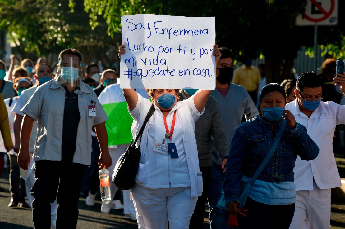 A health worker hold a sign reading, "I am a nurse. I fight for you and for my life," as she takes part in a protest in demand of medical material to care for COVID-19 patients, in Mexico City on April 13.
