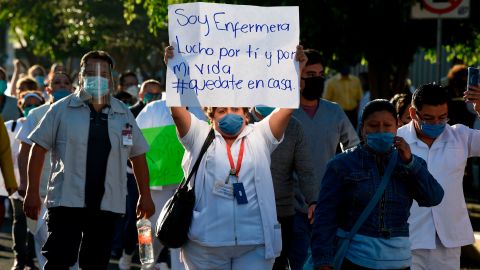 A health worker hold a sign reading, "I am a nurse. I fight for you and for my life," as she takes part in a protest in demand of medical material to care for COVID-19 patients, in Mexico City on April 13.