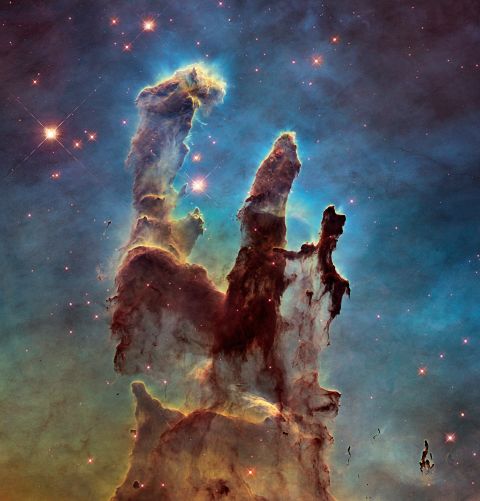 Astronomers combined several Hubble images taken in 2014 to create an upgraded view of the Hubble's iconic 1995 "Pillars of Creation" image. The new image shows a wider view of the pillars, which stretch about 5 light-years high. The pillars are part of a small region of the Eagle Nebula, which is about 6,500 light years from Earth.