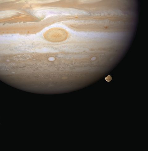 Hubble snapped this image in 2007 of Ganymede appearing to peek out from beneath Jupiter. Ganymede is the largest moon in our solar system, and it's even bigger than Mercury.