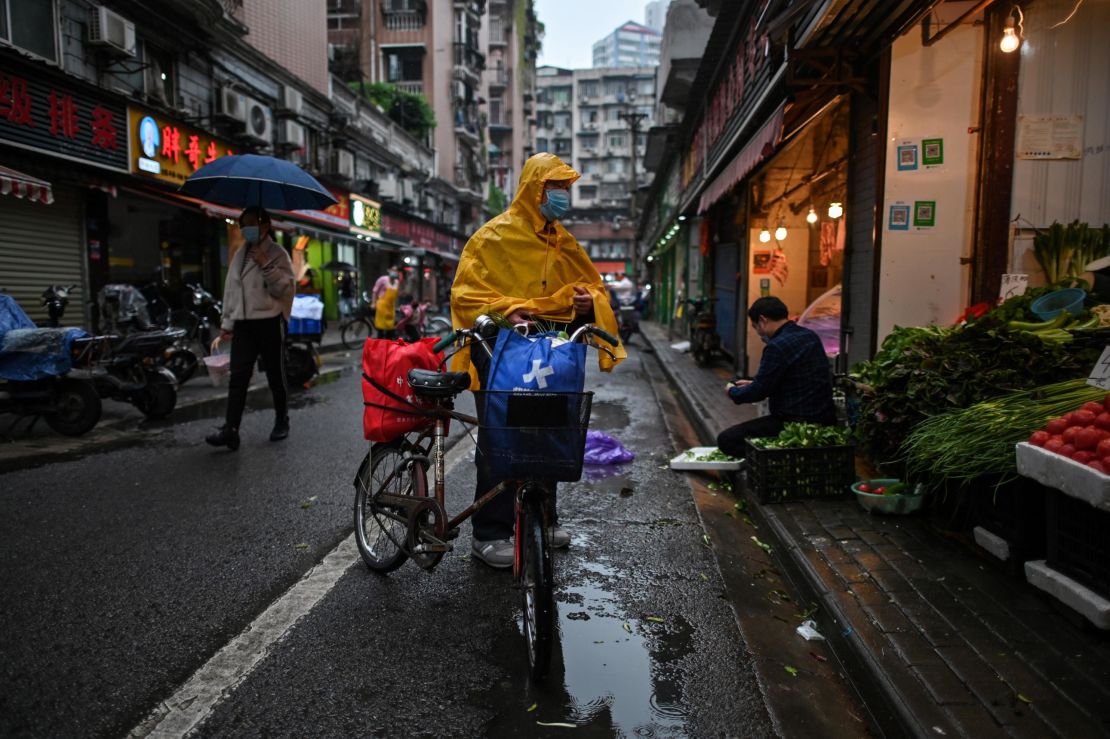 A man wearing a face mask arrives to buy vegetables at a stall in Wuhan in China's central Hubei province on April 18.