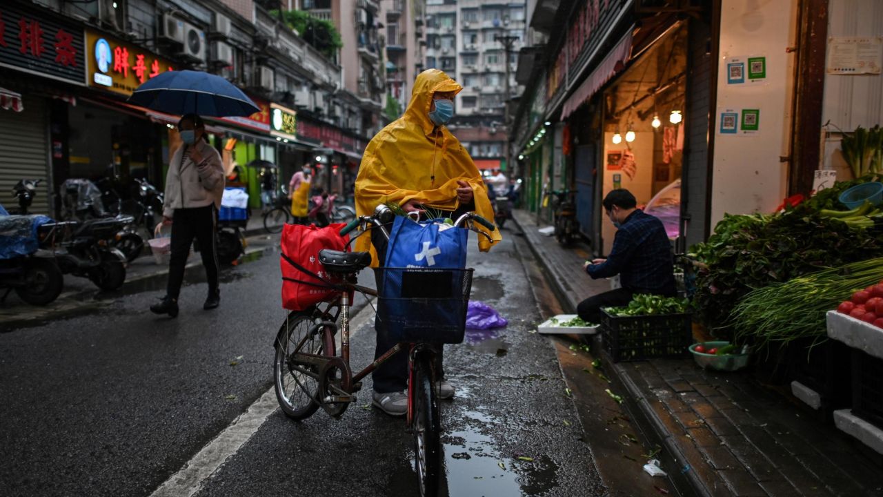 A man wearing a face mask arrives to buy vegetables at a stall in Wuhan in China's central Hubei province on April 18.