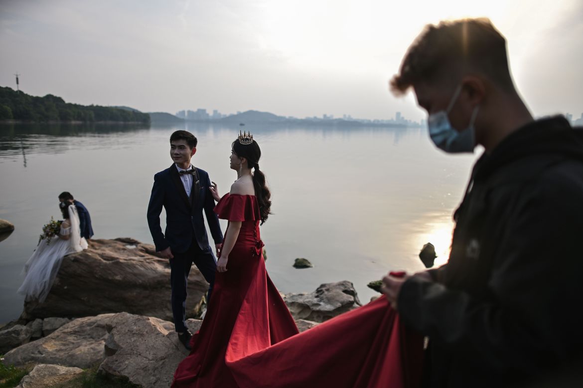A couple poses for a wedding photo in Wuhan, China, on Sunday, April 19. For more than two months, <a href="https://www.cnn.com/interactive/2020/04/world/wuhan-coronavirus-cnnphotos/" target="_blank">the city was sealed off from the outside world.</a> Weddings in the city were postponed.