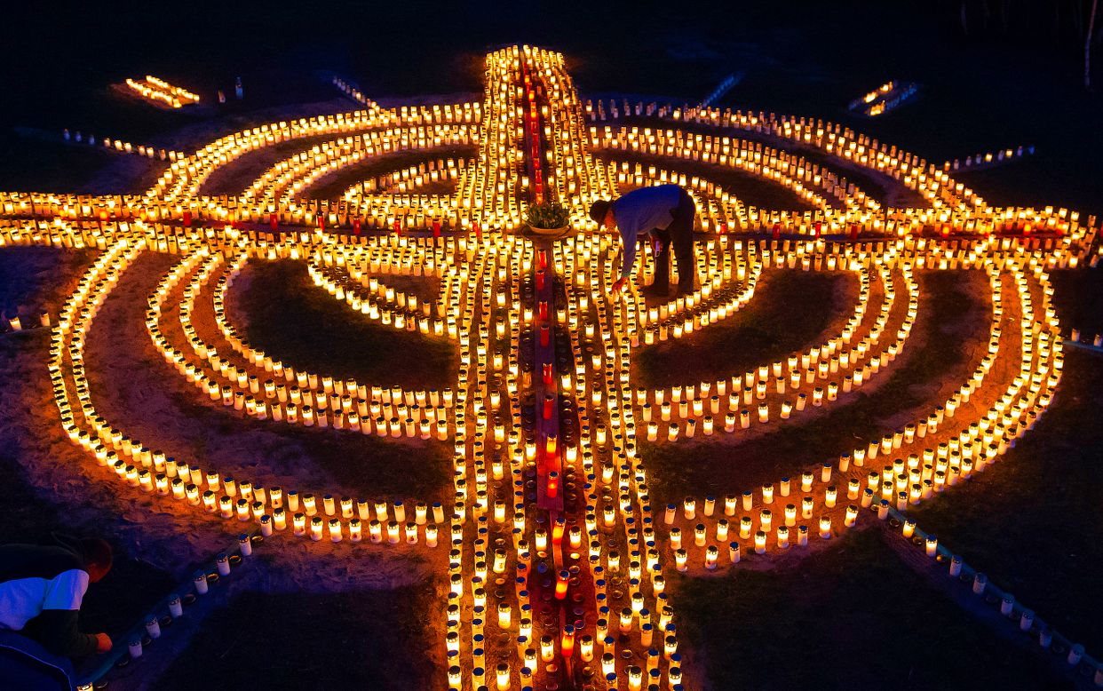 Candles form a giant cross in Zella-Mehlis, Germany, on Friday, April 17. Volunteers lit close to 4,000 candles in memory of coronavirus victims in Germany.