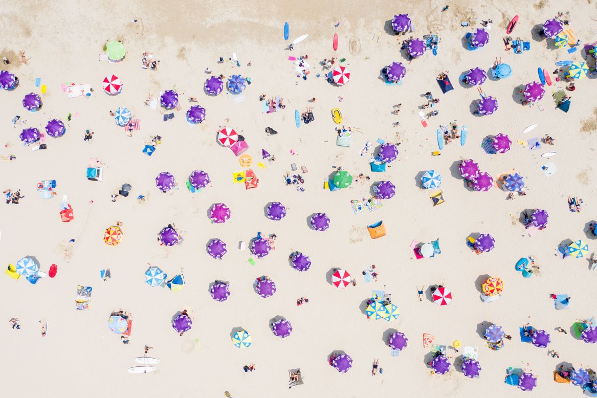 This aerial photo shows people gathered on a beach in Hong Kong on Sunday, April 19.