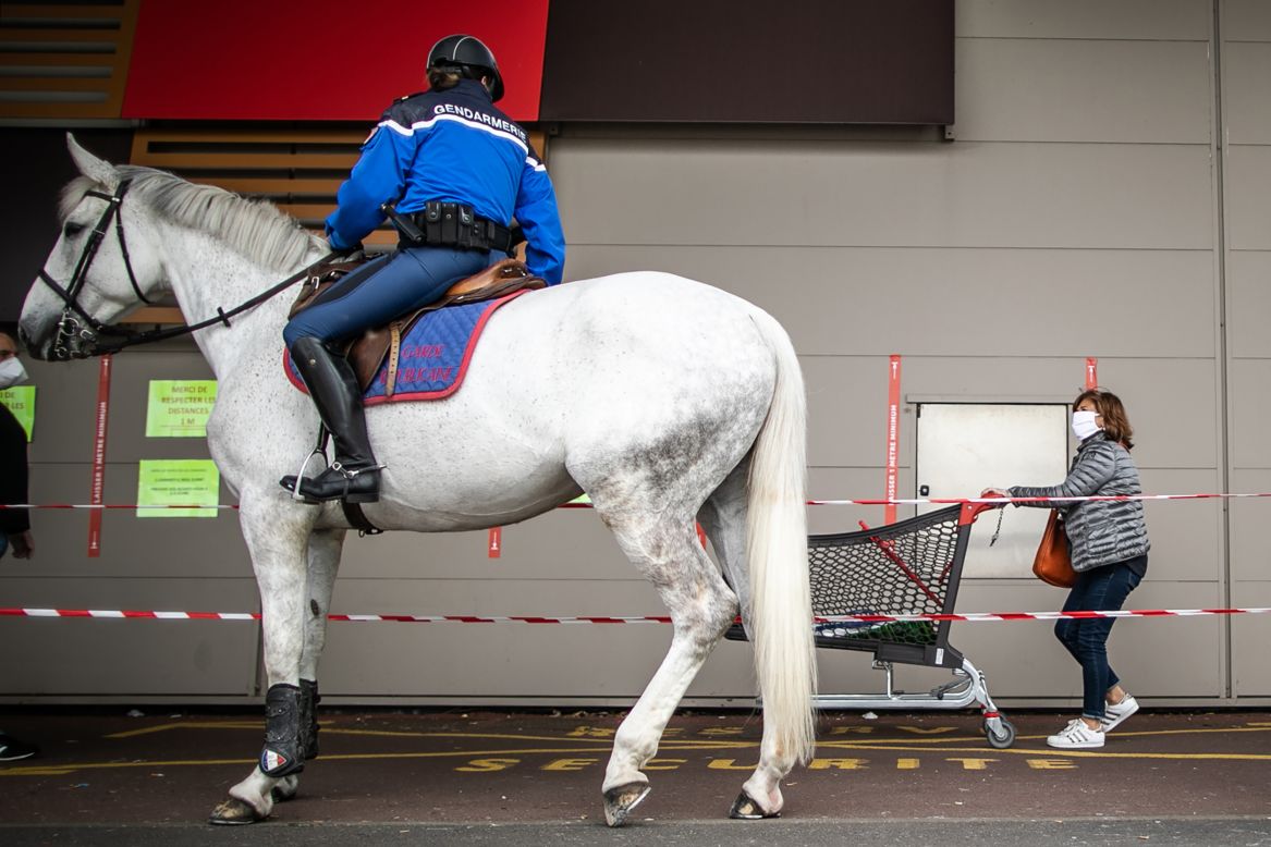 A mounted gendarme is stationed outside a supermarket in Courseulles-sur-Mer, France, on Friday, April 17.