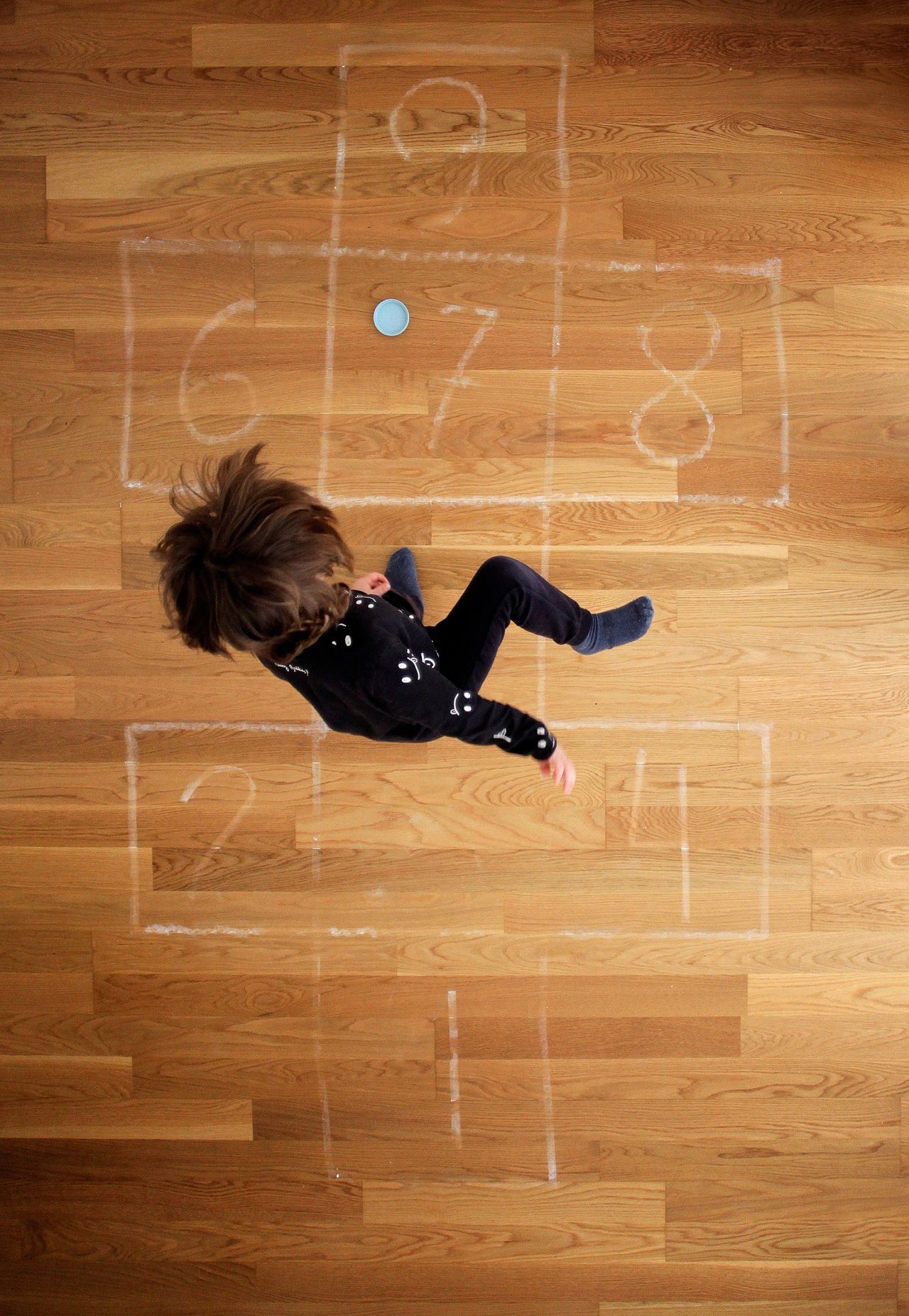 A boy plays hopscotch at his home in A Coruna, Spain. 
