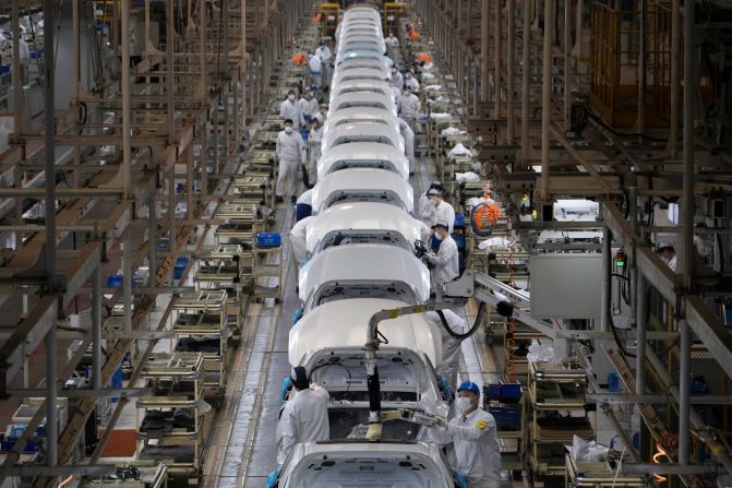 Workers assemble cars at a Dongfeng Honda factory in Wuhan on April 8, the day the city's unprecedented <a href="index.php?page=&url=https%3A%2F%2Fwww.cnn.com%2Finteractive%2F2020%2F04%2Fworld%2Fwuhan-coronavirus-cnnphotos%2Findex.html" target="_blank">76-day lockdown</a> was lifted.