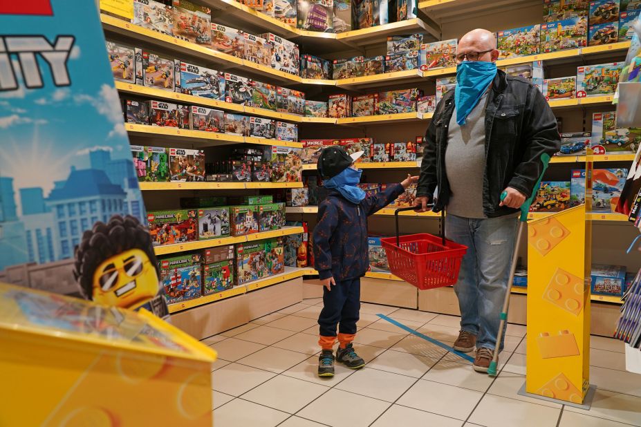 A child and his father shop at a toy store in Berlin that reopened on April 22. It was the first time the store was open since March.