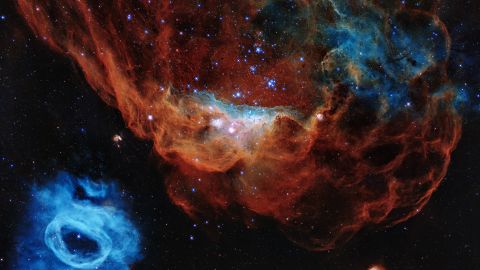 This new Hubble image of a giant red nebula and smaller blue neighbor nebula has been released to commemorate the 30th anniversary of the telescope.