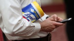 SAN FRANCISCO, CALIFORNIA - MARCH 16: An attendee holds a container of Lysol disinfecting wipes as San Francisco Mayor London Breed (R) speaks during a press conference at San Francisco City Hall on March 16, 2020 in San Francisco, California. San Francisco Mayor London Breed announced a shelter in place order for residents in San Francisco until April 7. The order will allow people to leave their homes to do essential tasks such as grocery shopping and pet walking. (Photo by Justin Sullivan/Getty Images)