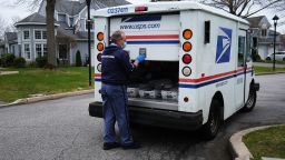 US Postal Service worker Lou Martini goes about his daily delivery route during the coronavirus pandemic on April 15, in Kings Park, New York. 