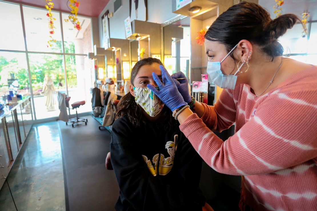 A customer gets her eyebrows waxed at a salon in Marietta, Georgia, on April 24. The salon had been closed for more than a month during the pandemic. 