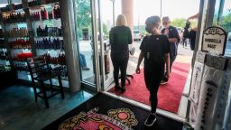 Employees and customers walk in to Three-13 Salon, Spa & Boutique on Friday, April 24, 2020, in Marietta, Ga. The salon had been closed for more than a month due to the new coronavirus. Barber shops, nail salons, gyms and a few other businesses reopened in Georgia on Friday as the Republican governor eased a month-long shutdown despite warnings from health experts of a potential new surge of coronavirus infections