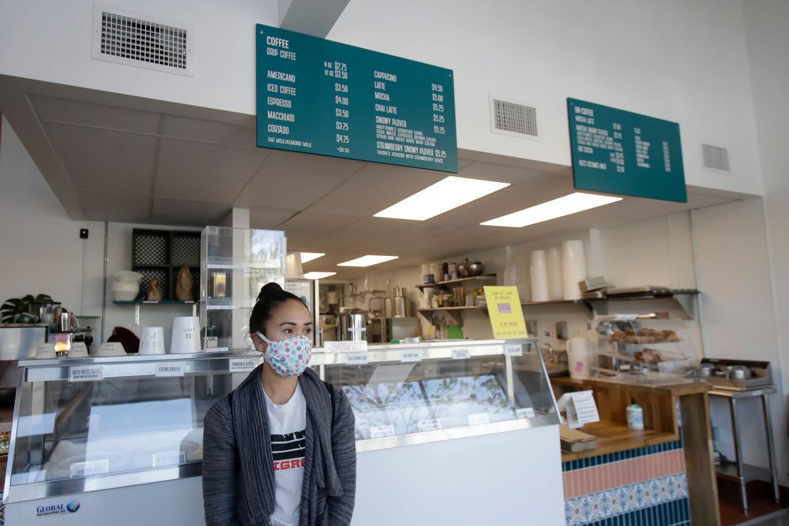 Rica Sunga-Kwan, owner of Churn Urban Creamery, wears a mask while interviewed at her shop in San Francisco on Thursday, April 23.