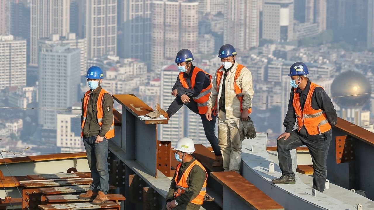 Construction workers wear face masks at a building site in Wuhan on April 24.
