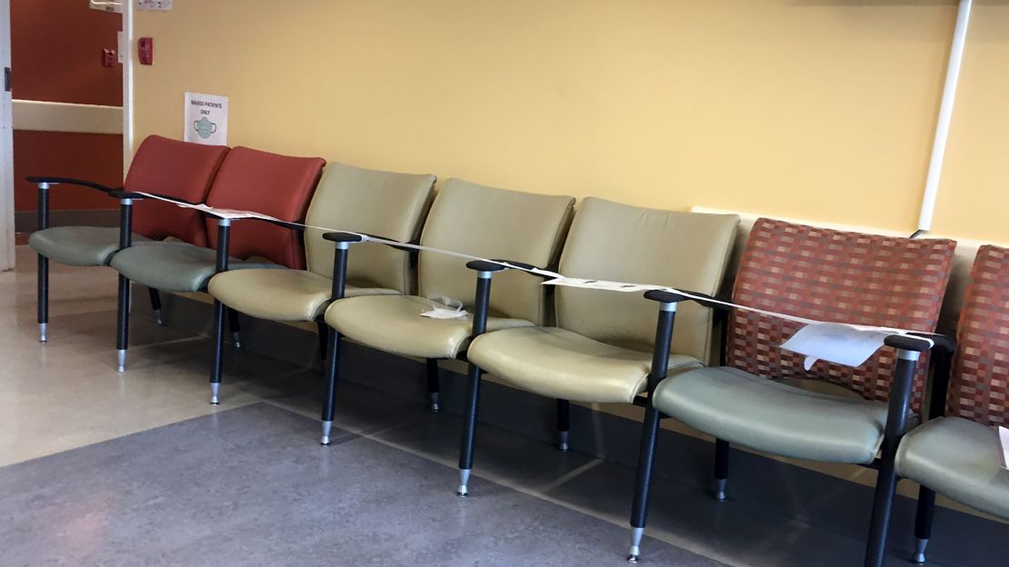 A row of seats in a hospital waiting room are taped off so patients won't sit in them. It's a social distancing measure other health care providers have taken.
