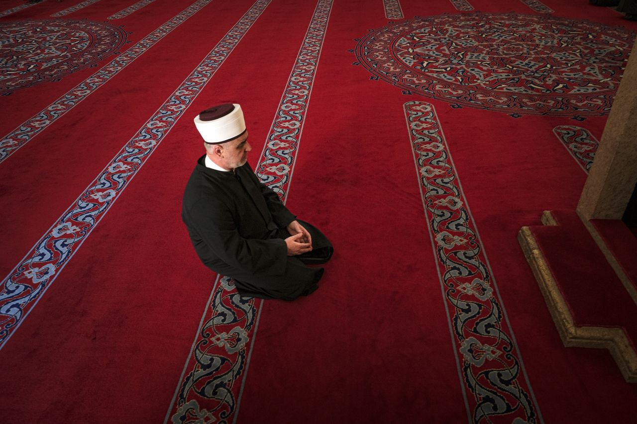 A cleric attends prayers in a mostly empty mosque in Sarajevo, Bosnia and Herzegovina.