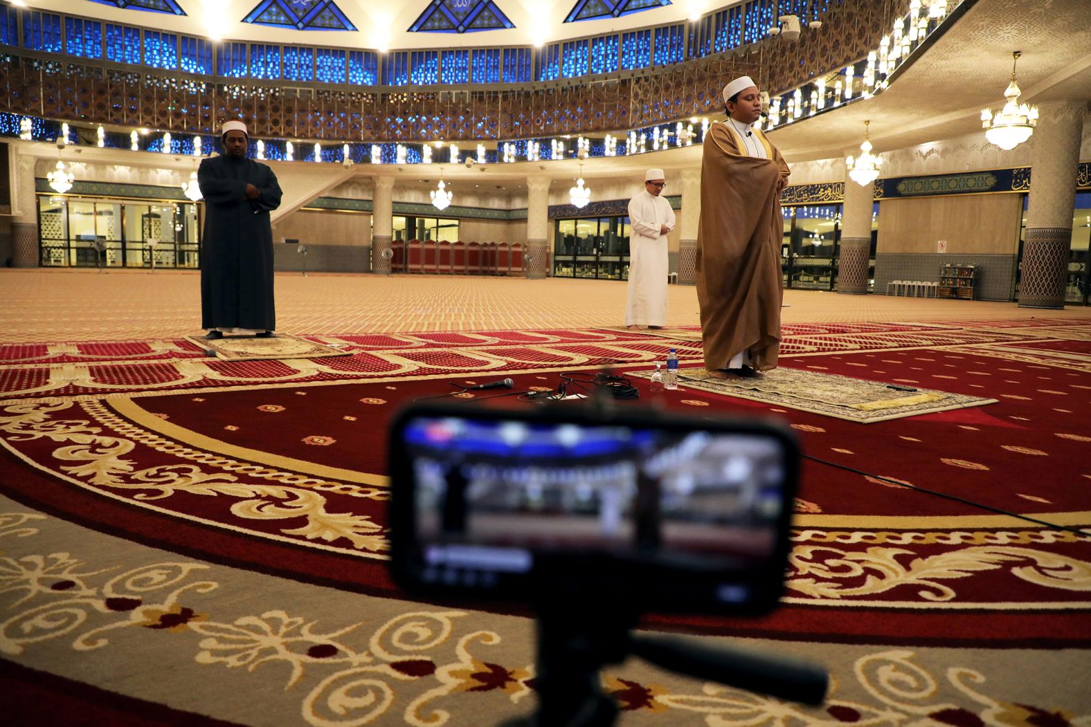 An imam leads a prayer that was broadcast live from an empty National Mosque in Kuala Lumpur, Malaysia.