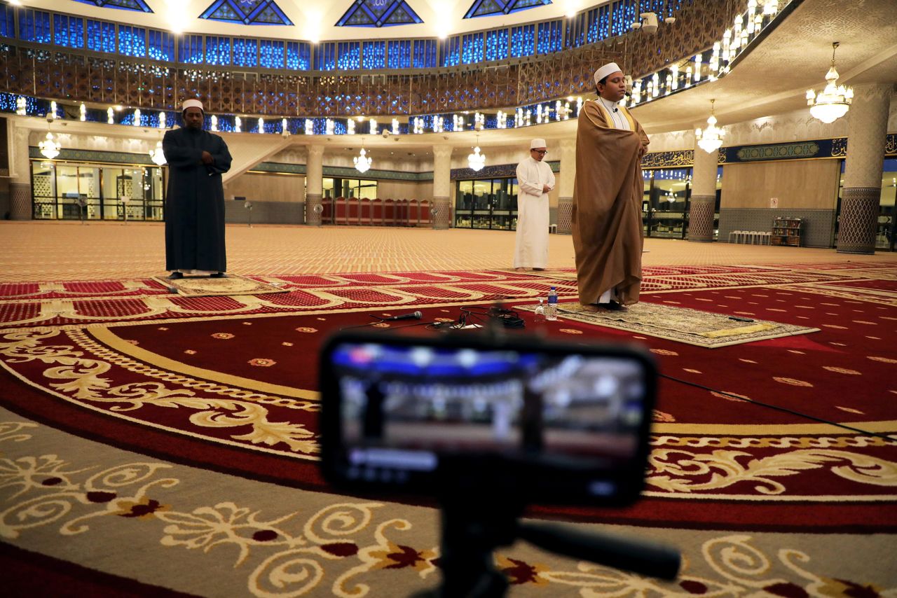 An imam leads a prayer that was broadcast live from an empty National Mosque in Kuala Lumpur, Malaysia.