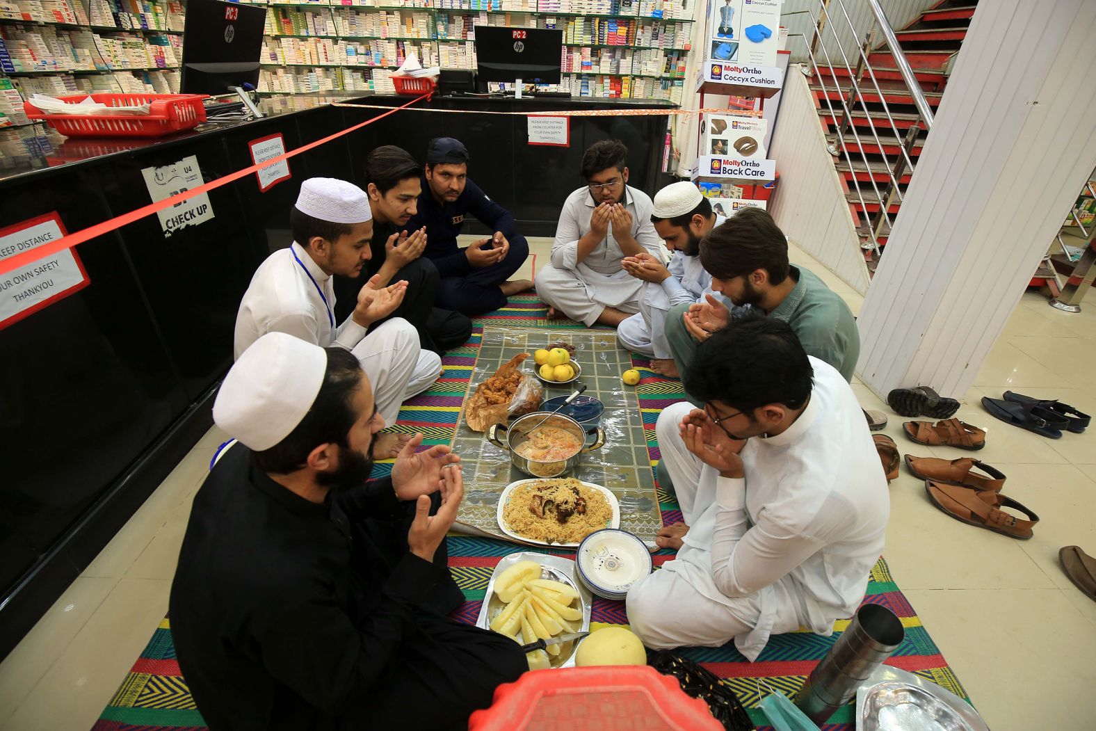 Workers pray as they wait to break the fast at their shop in Peshawar, Pakistan, on April 24. 