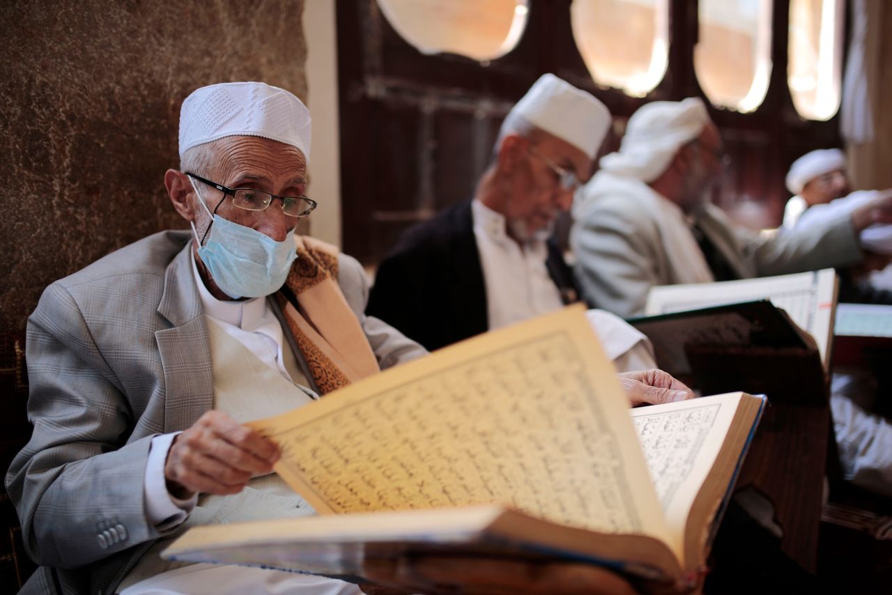 Men read verses of the Quran at the Grand Mosque in Sanaa, Yemen.