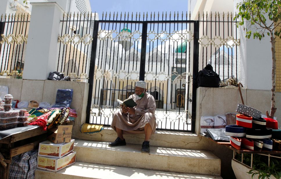 A man reads the Quran outside the closed Jamia Mosque in Nairobi, Kenya, on April 24.
