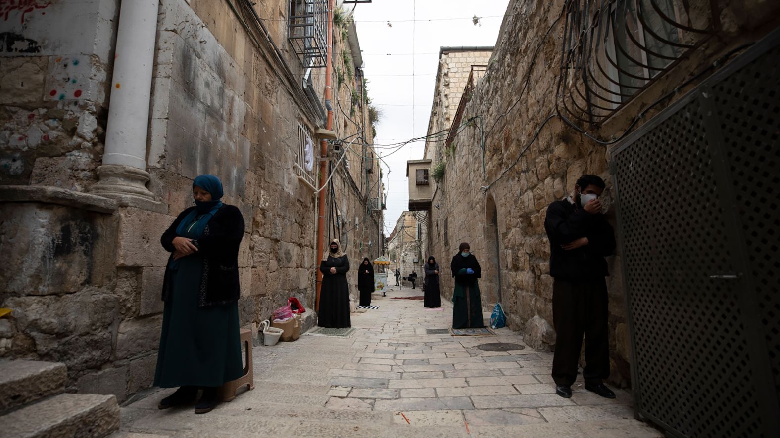 People keep their distance from one another as they pray next to the gate of the Al-Aqsa Mosque in Jerusalem on April 24.