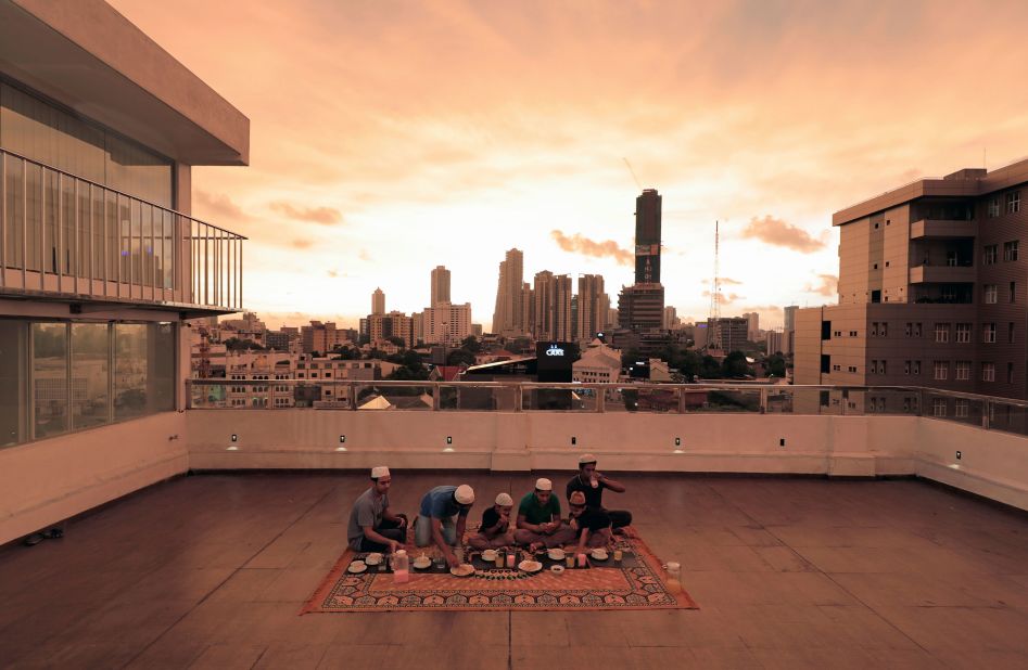 A family breaks their fast on the rooftop of their home in Colombo, Sri Lanka, as the sun goes down on April 25.