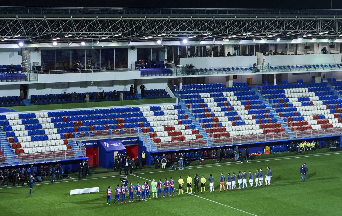 Eibar SAD and Real Sociedad players lined up in an empty stadium on March 10 after fans were barred from attending the match due to the coronavirus pandemic.