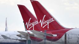 Tailfins of parked Virgin Atlantic passenger aircraft are pictured on the apron at Heathrow Airport, west of London on April 2, 2020, as life in Britain continues during the nationwide lockdown to combat the novel coronavirus COVID-19 pandemic. - Prime Minister Boris Johnson said Britain would "massively increase testing" amid a growing wave of criticism on Thursday about his government's failure to provide widespread coronavirus screening. (Photo by Ben STANSALL / AFP) (Photo by BEN STANSALL/AFP via Getty Images)